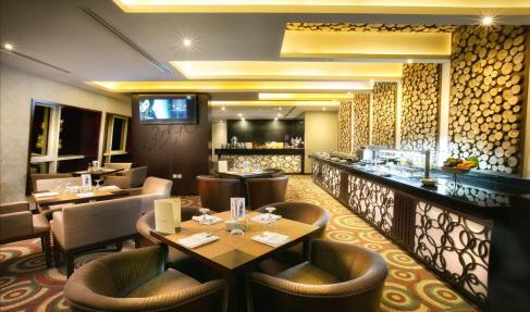 Ghaya Grand Hotel buffet line with log-slice accent wall