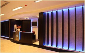 Al Ghandi Electronics reception desk with lit accent wall