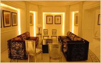 Richly styled lounge interior with custom seating and framed art